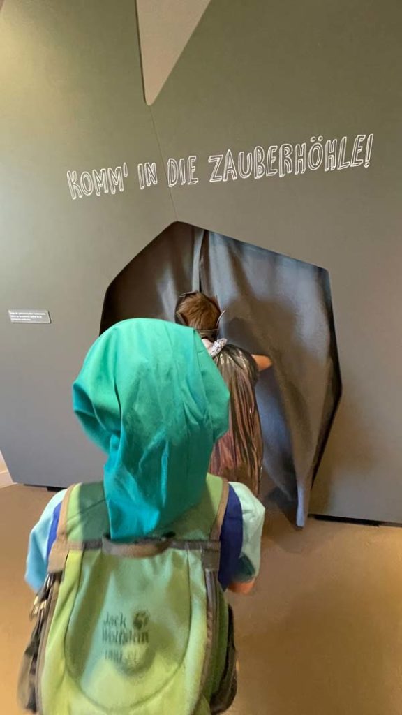 Zwei Kinder gehen in die Zauberhöhle im GrimmsMärchenReich Museum in Hanau